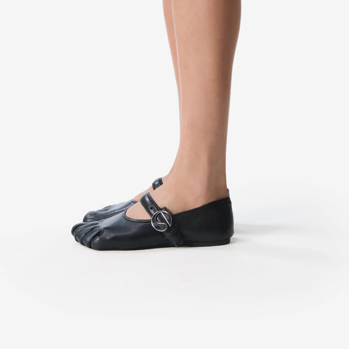 Sculpted foot-shaped flats in soft black leather